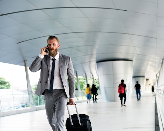 businessmen-walk-call-phone-luggage-business-trip_53876-42650